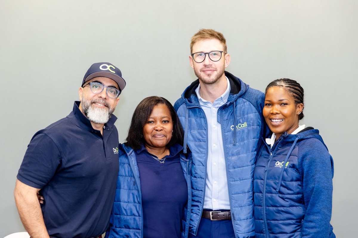 Four members of the OnCall team wearing OnCall branded clothing